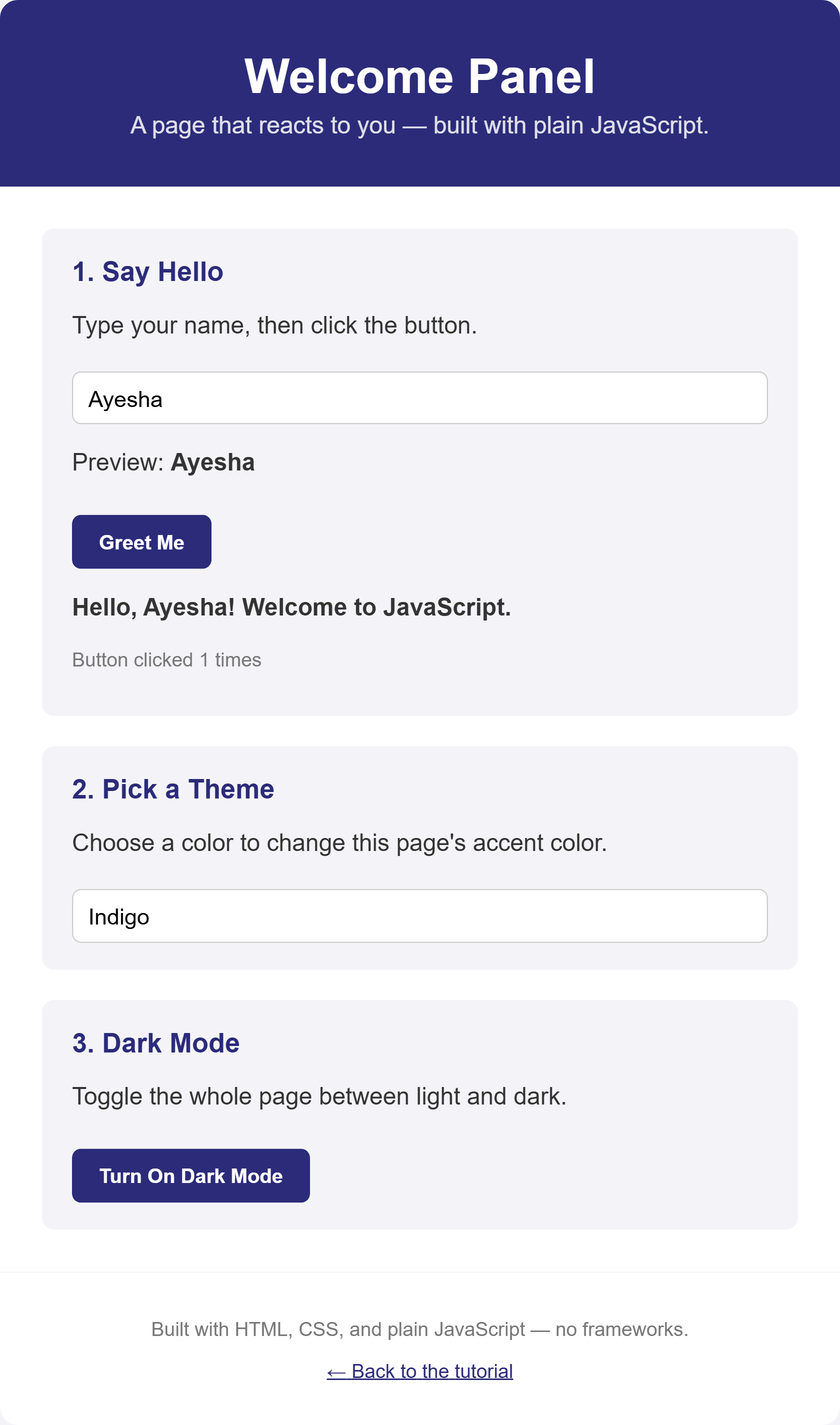 Rendered output: a white card titled "Welcome Panel" on a light gray page, showing a name input with "Ayesha" typed in, a live preview reading "Preview: Ayesha", a "Greet Me" button, the message "Hello, Ayesha! Welcome to JavaScript.", a click counter reading 1, a theme color dropdown set to Indigo, and a "Turn On Dark Mode" button